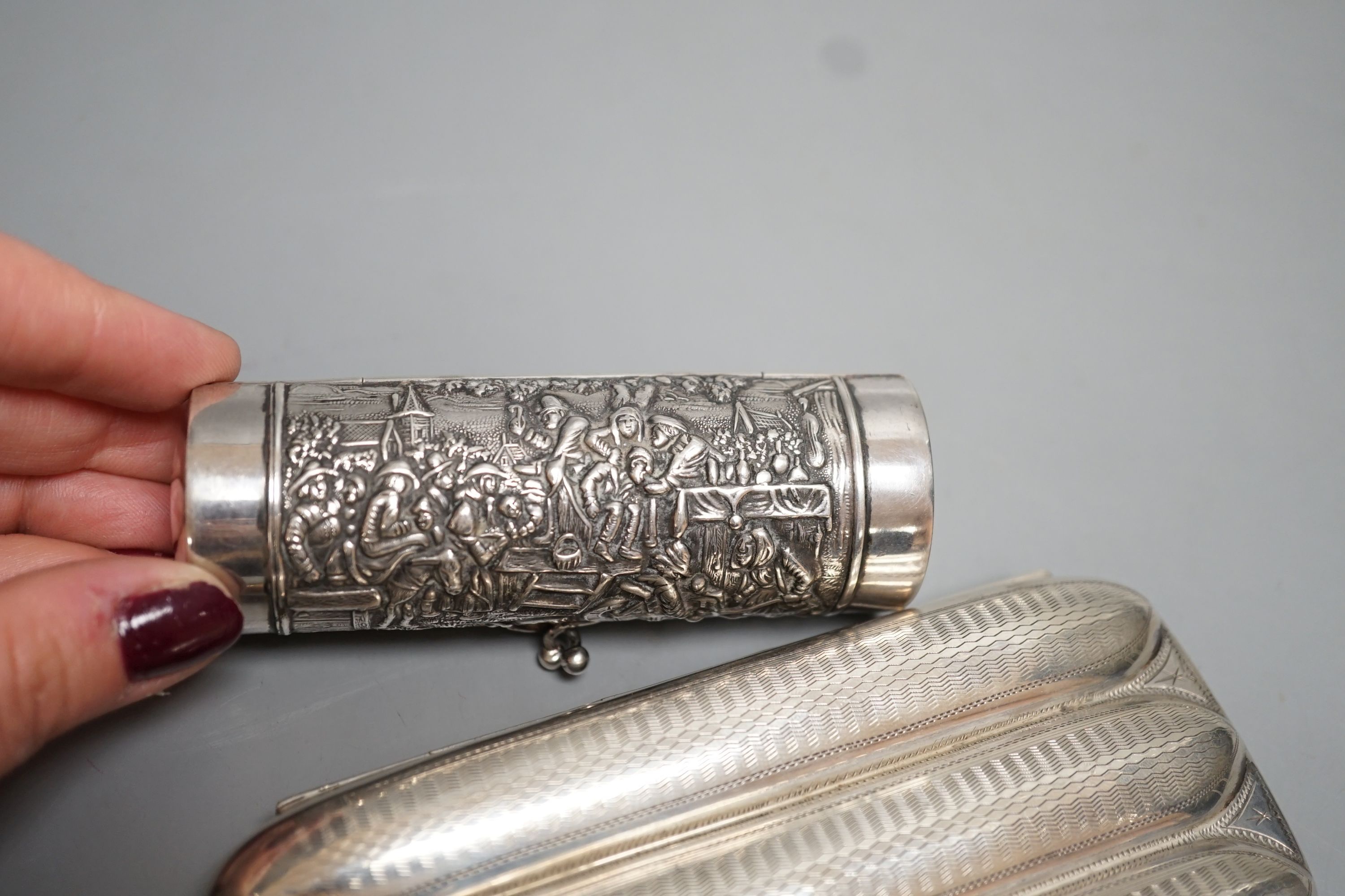 A George V silver three division cigar case, Birmingham, 1915, 13.1cm and a white metal cylindrical purse.